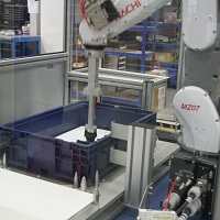 Robotic Packaging System Packs Filler Caps