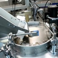 Centrifugal feeder system to feed, orientate, and load a range of Coin Blanks