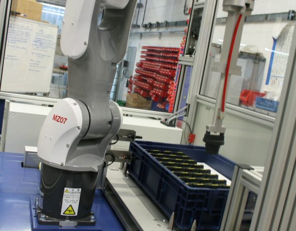 Robotic Packaging System Packs Filler Caps