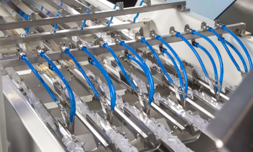 The FlexType L is being used to handle plastic inserts.