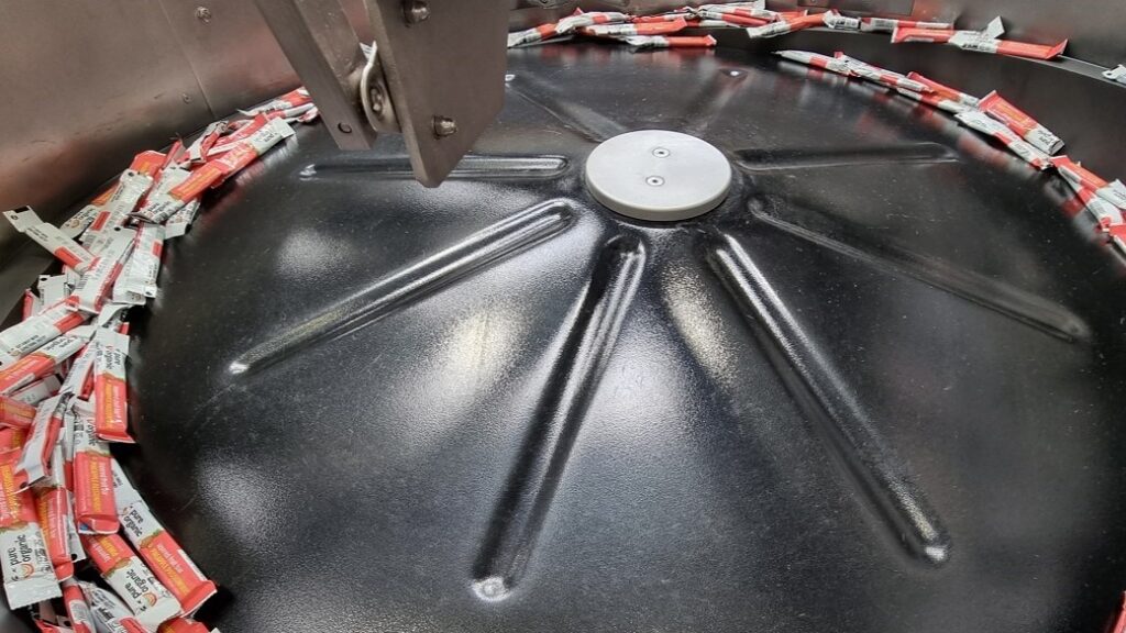 Centrifugal Feeder feeds and orientates Wrapped Fruit Bars