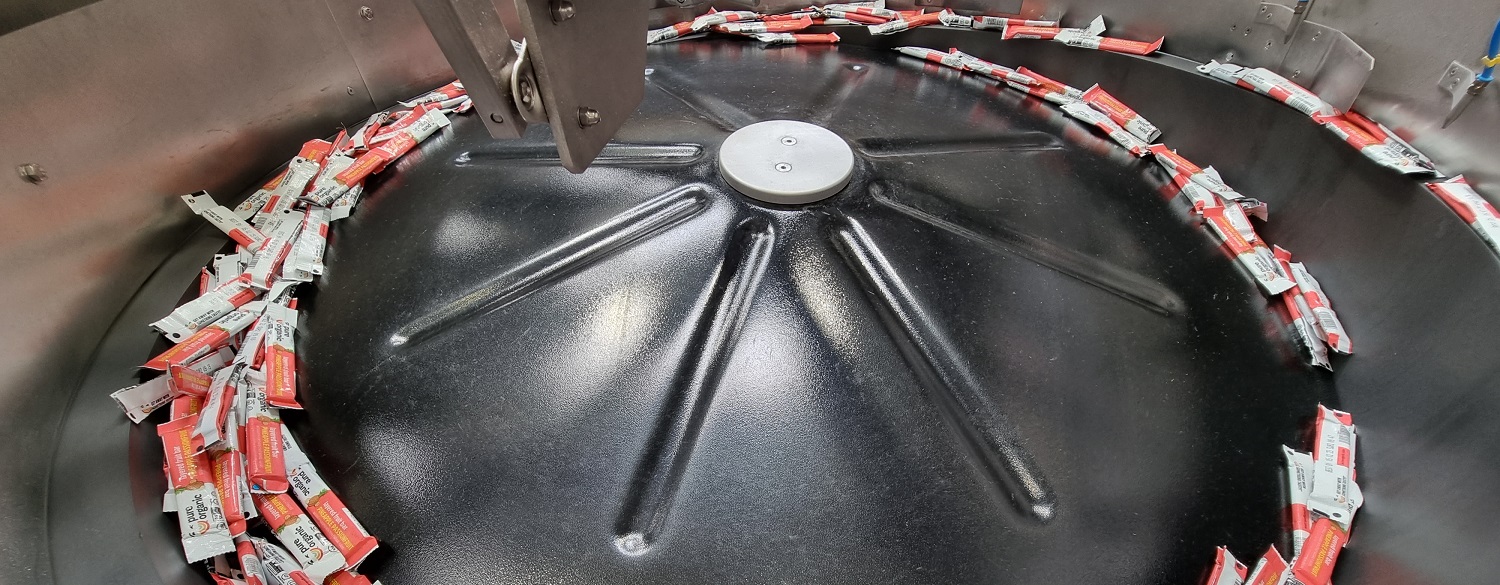 Centrifugal Feeder feeds and orientates Wrapped Fruit Bars