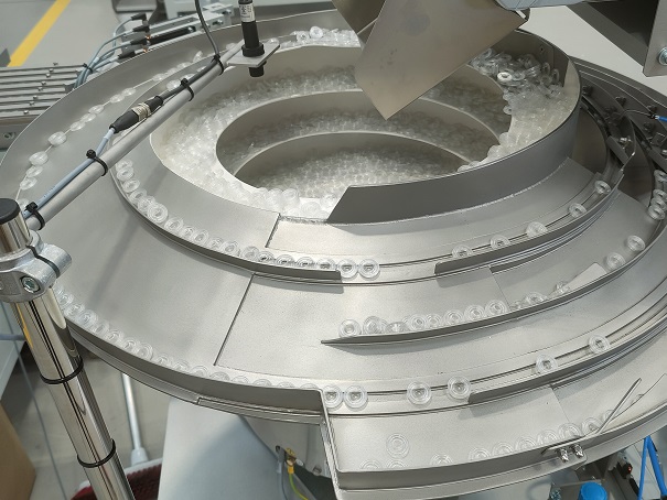 Bowl Feeder feeds and orientates Pharmaceutical Caps