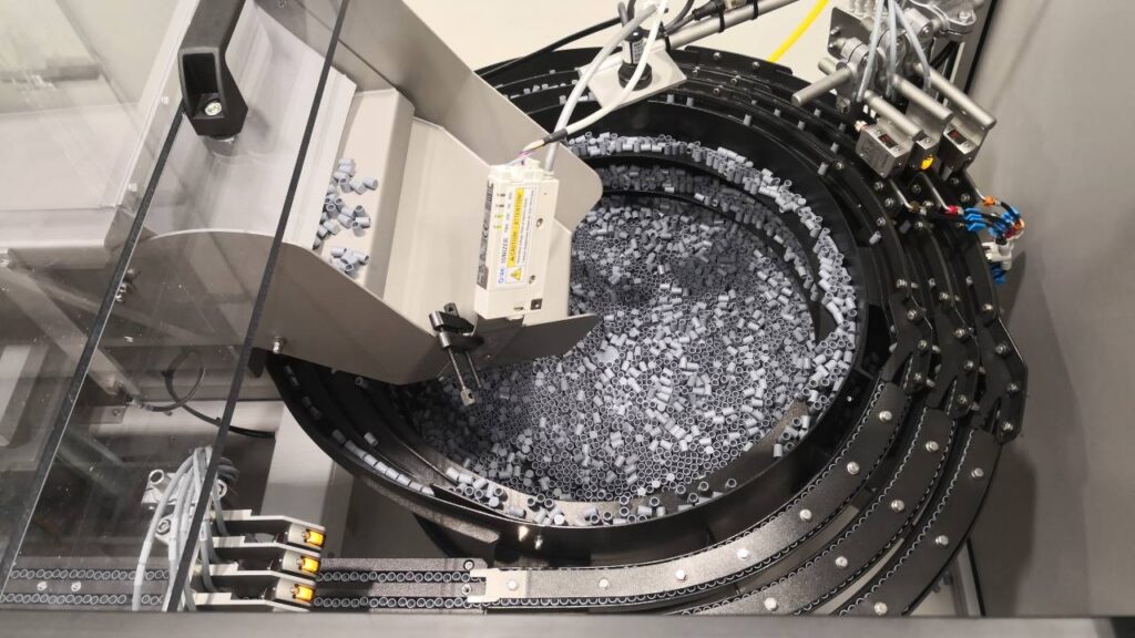 Multi-lane bowl feeder handles and orientates Spray Nozzle Tip Caps