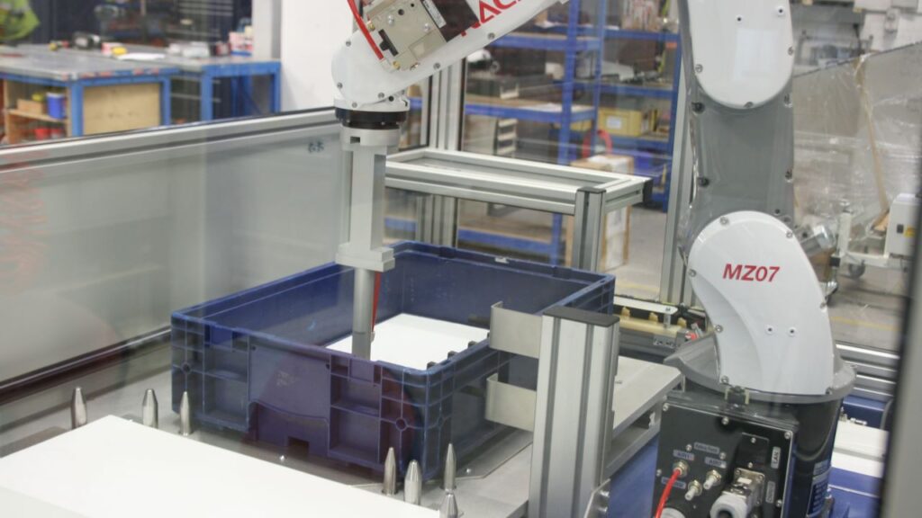 Robotic Packaging System Packs Filler Caps